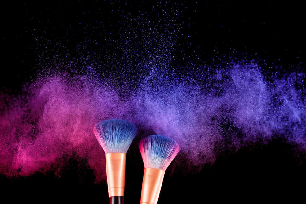 Make up brushes with blue and pink powder