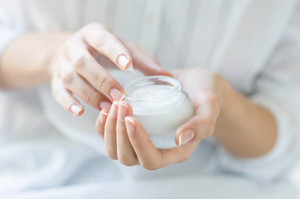 female hands holding moisturizer