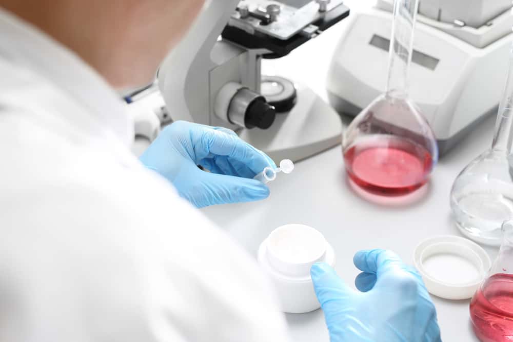 scientist mixes ingredients in a lab