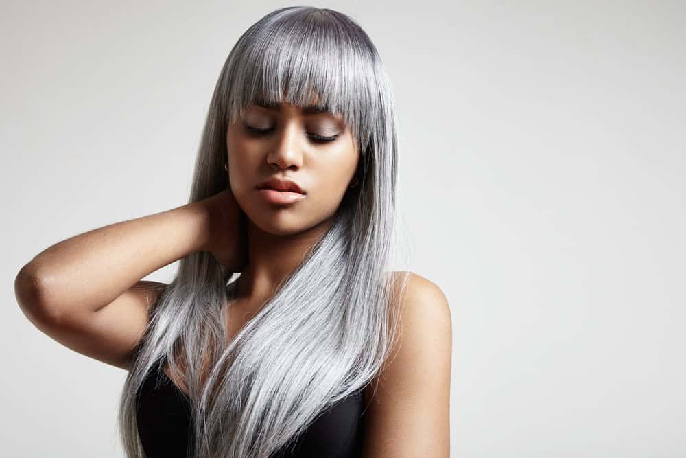 young Black woman with long grey hair and bangs