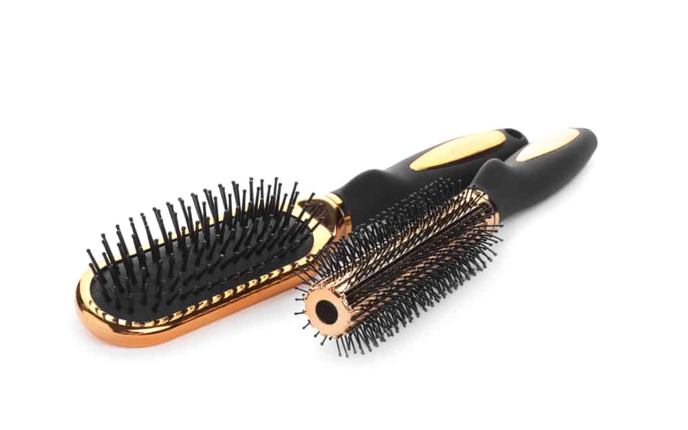 A round hairbrush and a paddle hairbrush