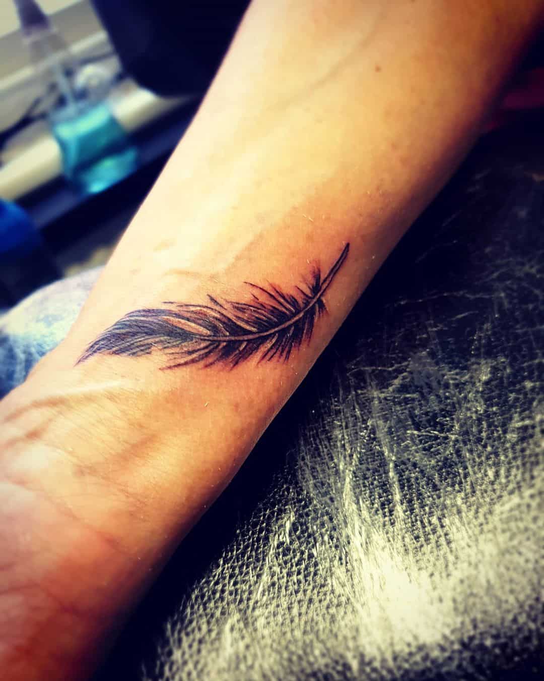 50 Small Wrist Tattoo Ideas - A Classic Feather