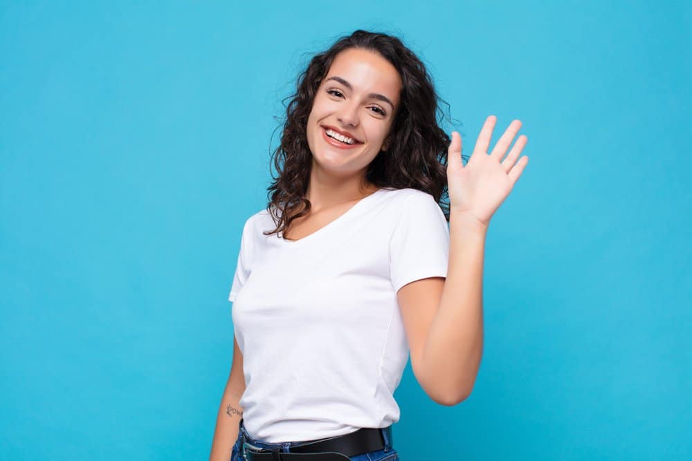 Woman with wavy hair waving