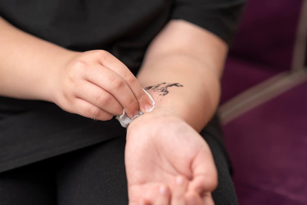 girl removing temporary tattoo