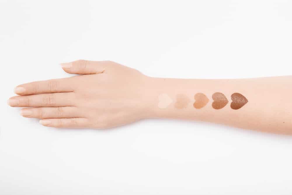 heart-shaped makeup swatches on arm