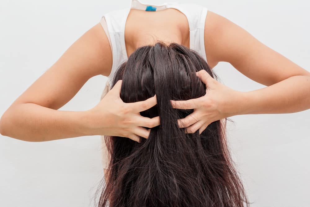 woman applying dry shampoo