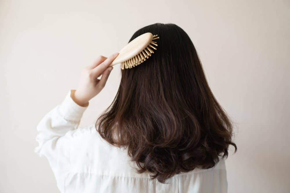 woman brushing black hair