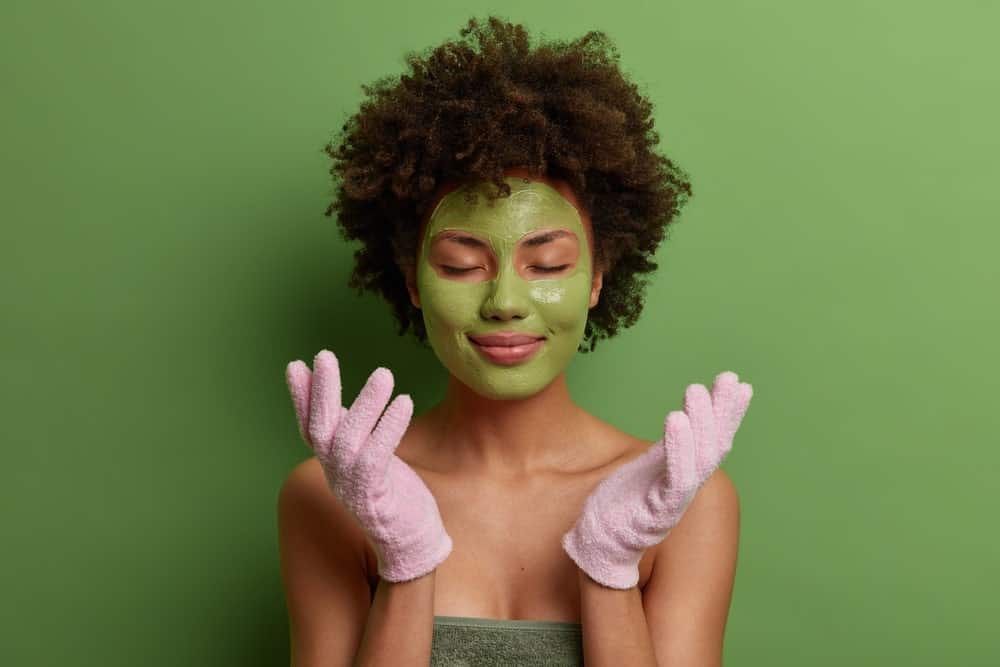 woman exfoliating with gloves