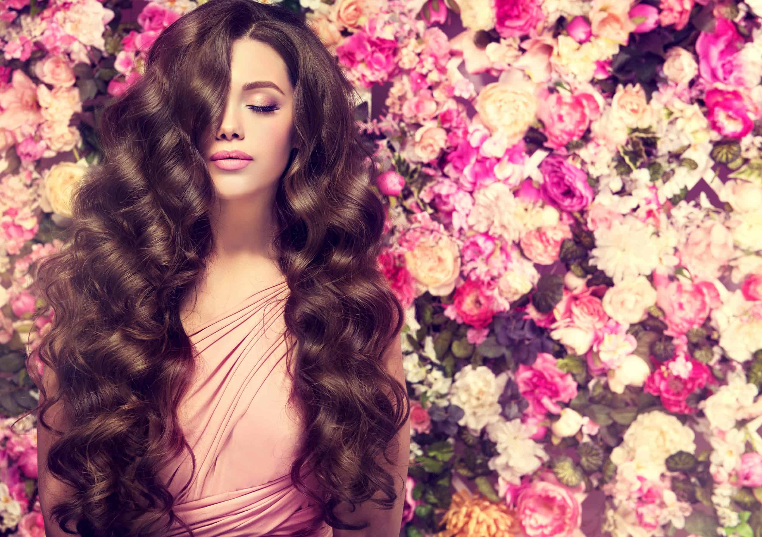 woman with permed hair on background of flowers