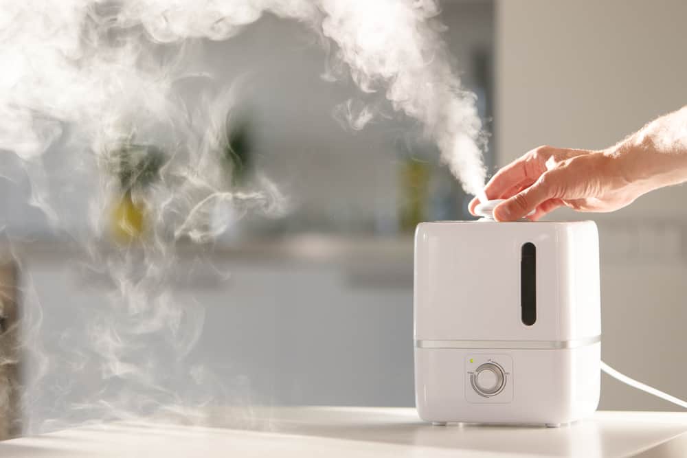 close up of hand turning on humidifier