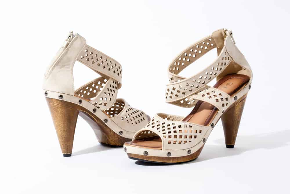 tan cone heeled sandals on a white background