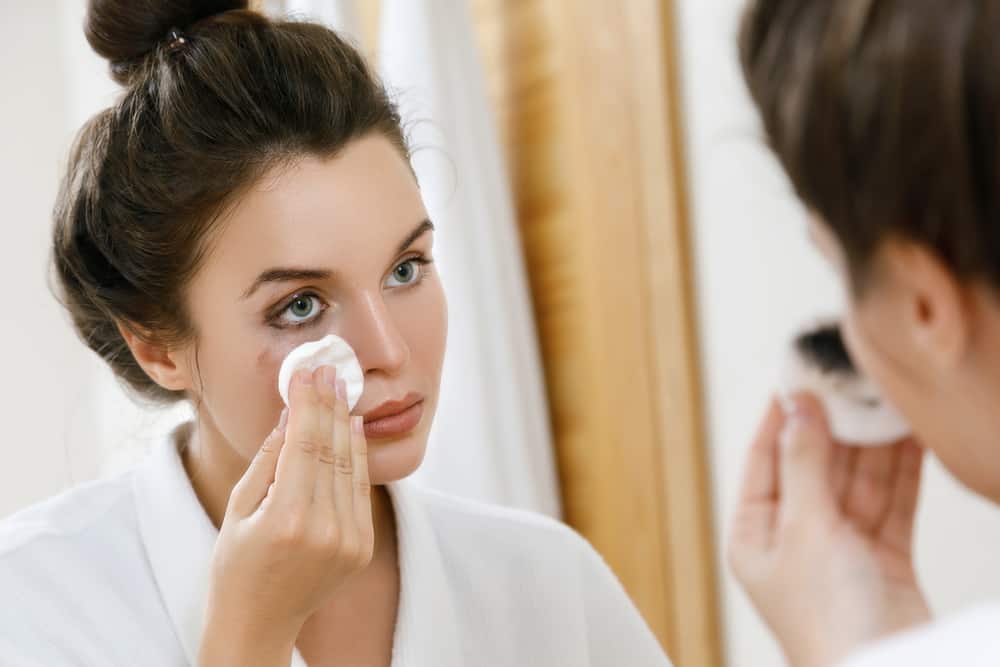 woman removing eyeliner