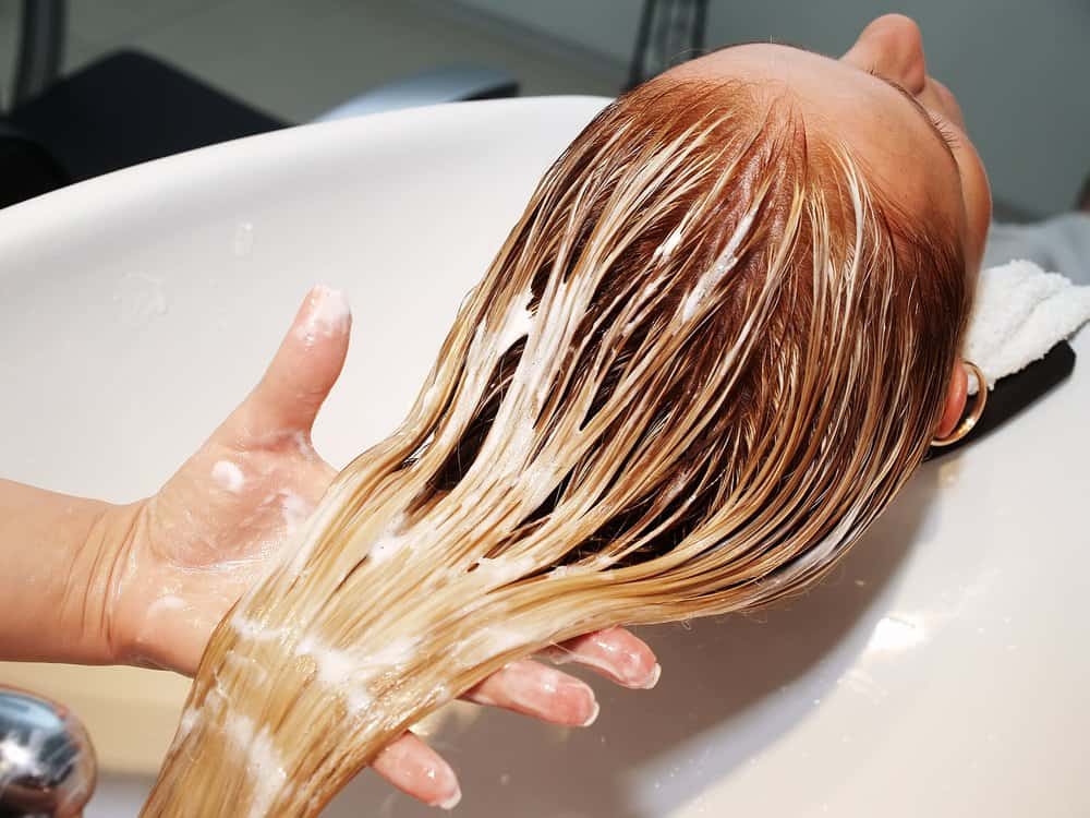 woman receiving hair treatment in salon