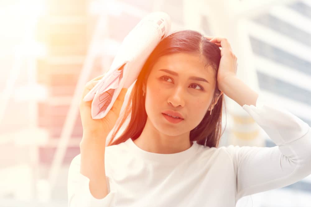 woman protecting hair from sun