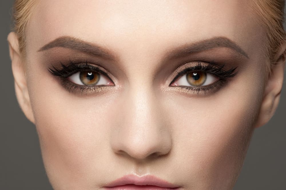 blonde woman with brown eyes and smokey eyeshadow