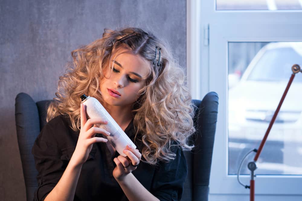 curly haired girl with hairspray