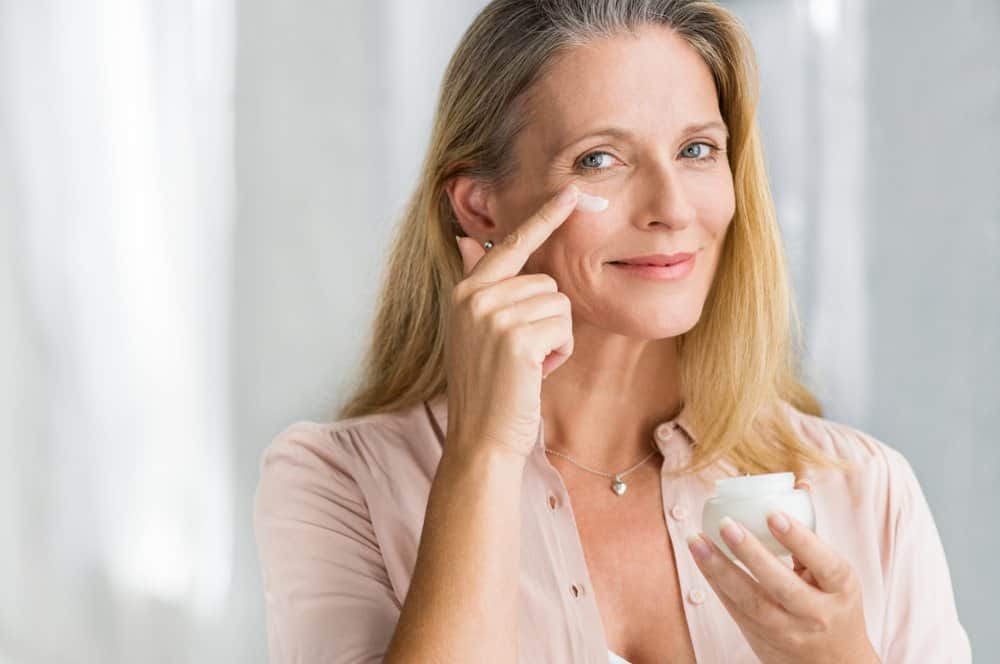 woman applying cream to skin