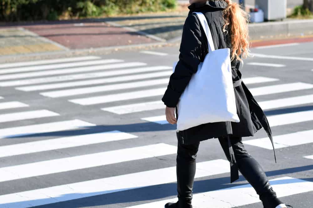 person carrying large tote bag