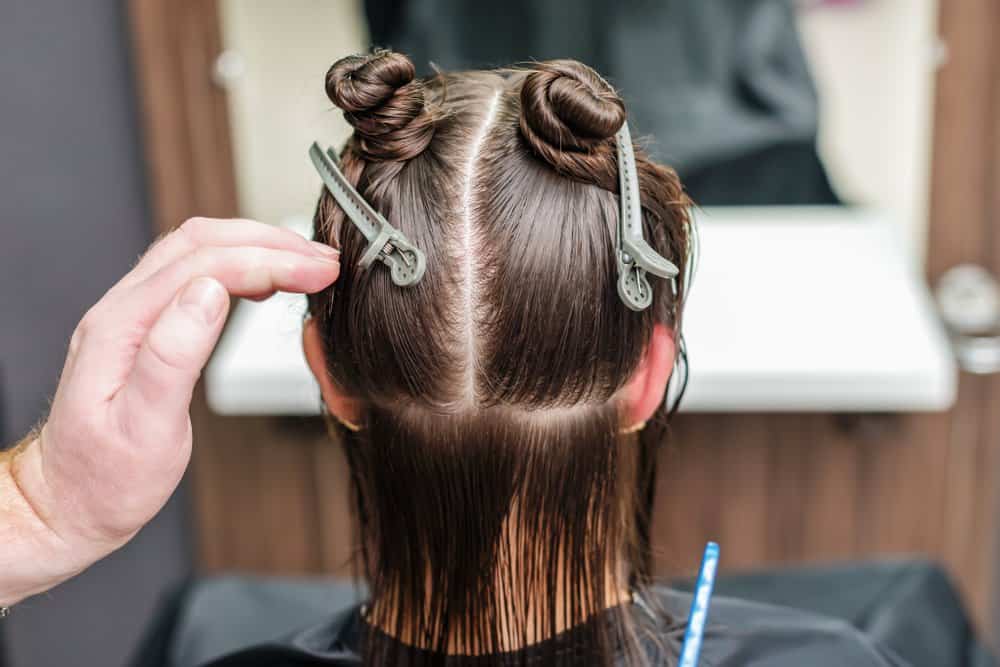 hairdresser sectioning hair