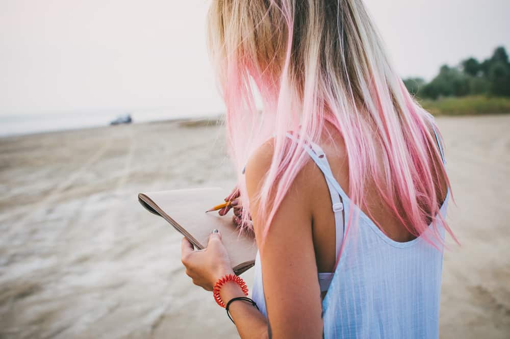 woman with pastel hair on beach