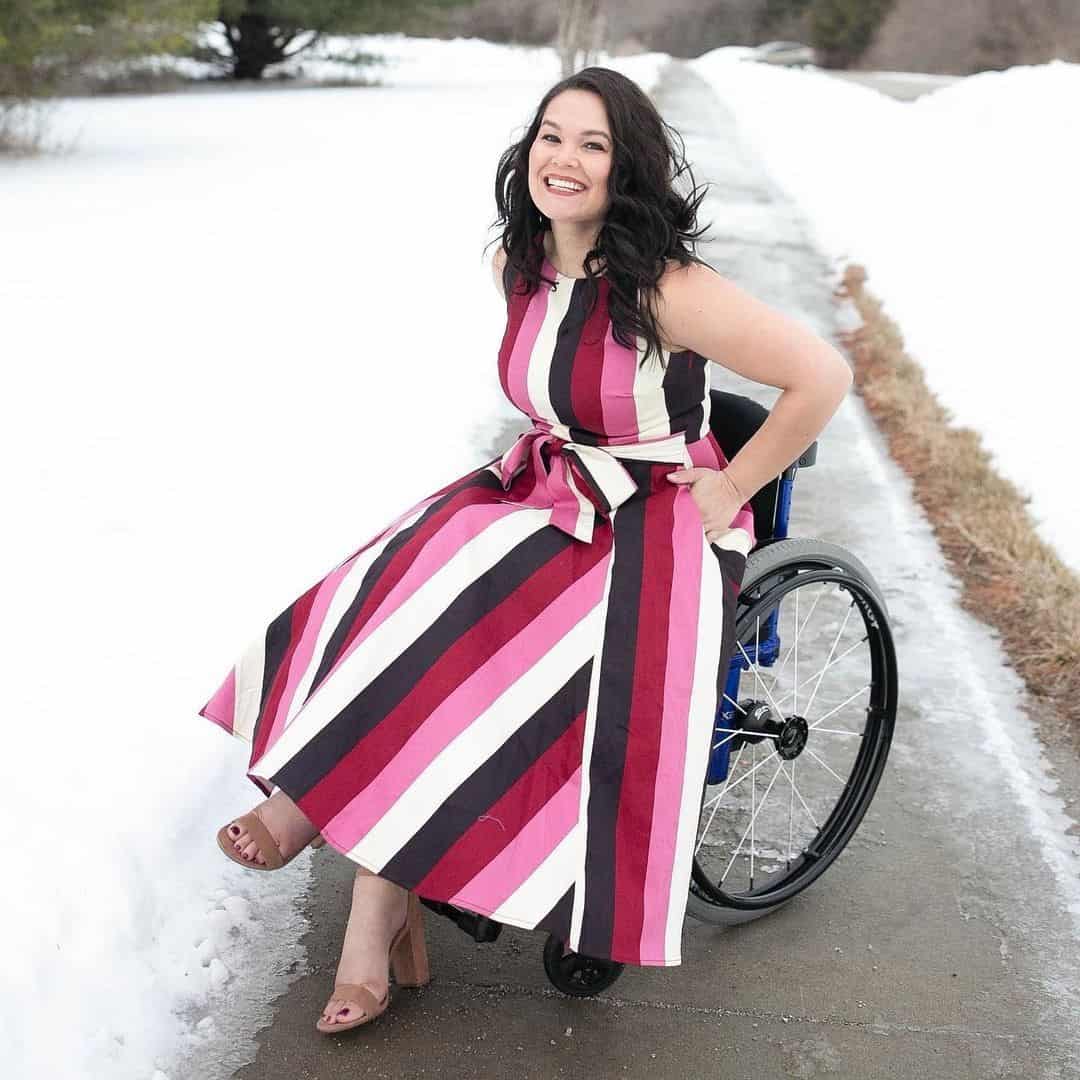 Model in a wheelchair wearing striped dress