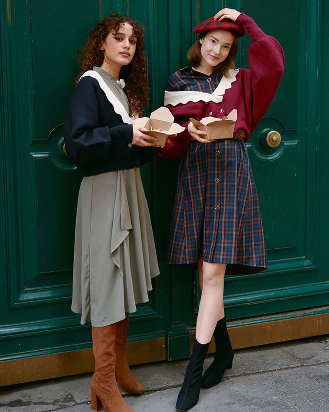 Two models in vintage outfits on a bench