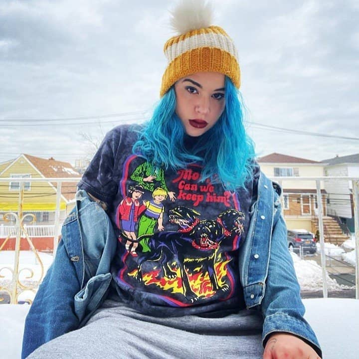 Woman with blue hair in graphic tee-shirt