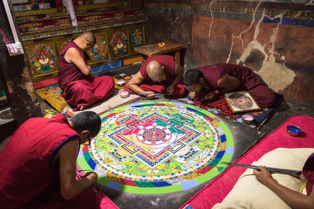 buddhist monks making sand mandala