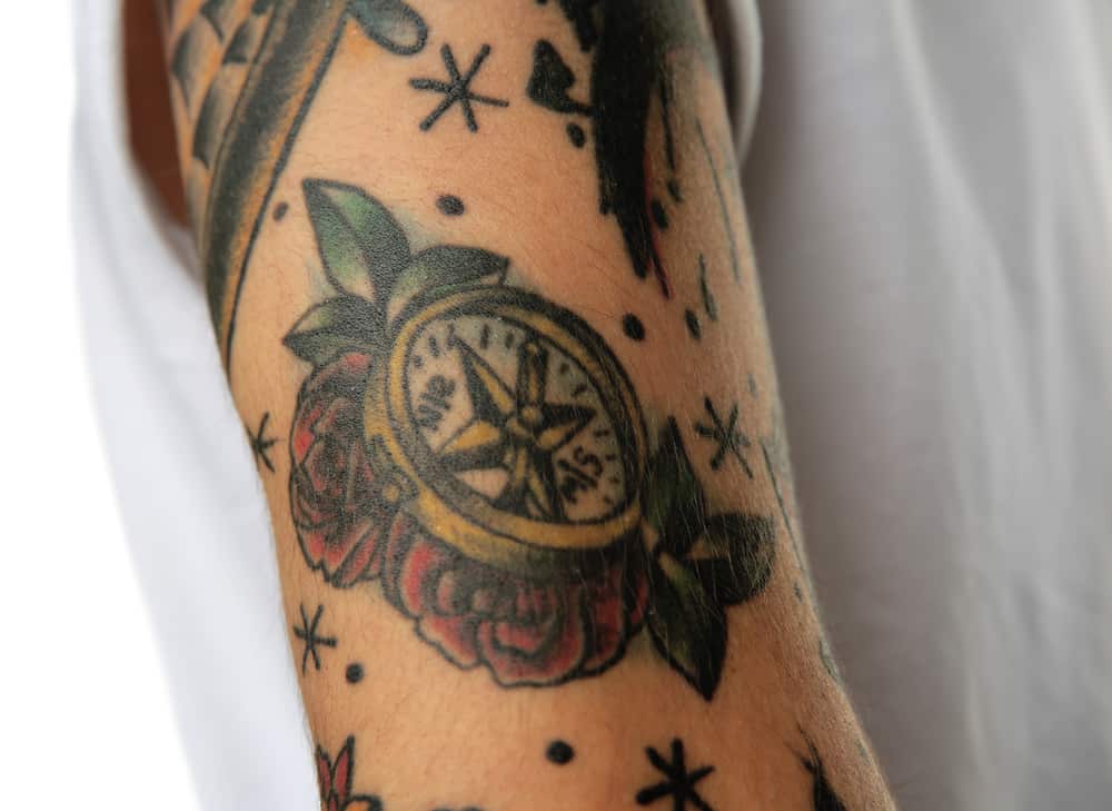 compass tattoo on male arm