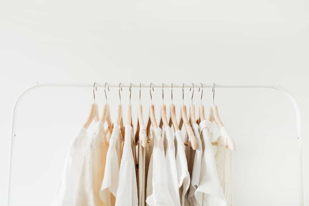 cream-colored blouses on a rack