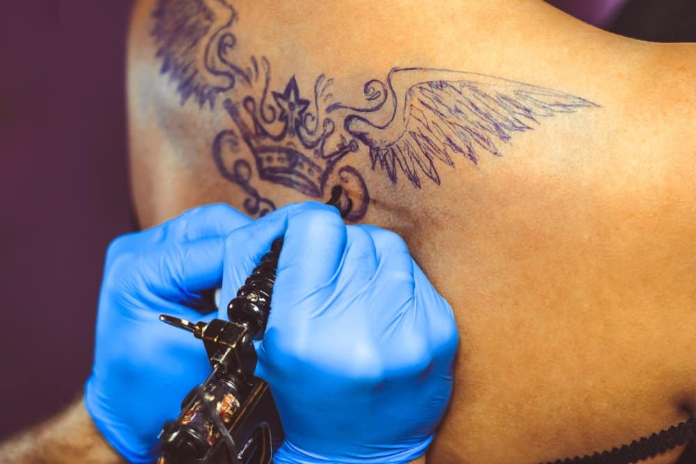 getting crown tattoo with wings