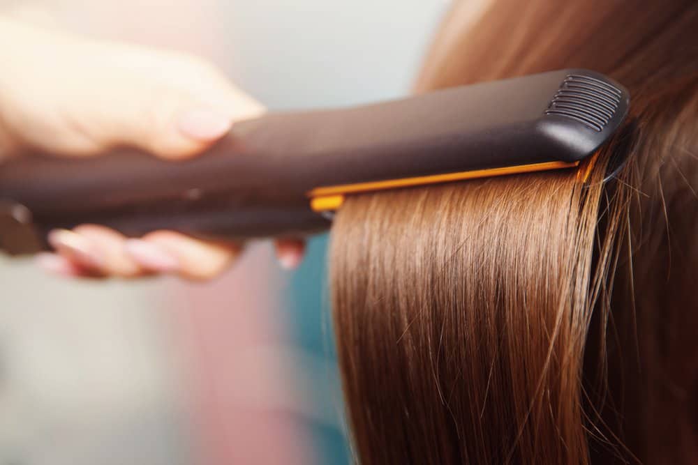 hair getting straightened by iron