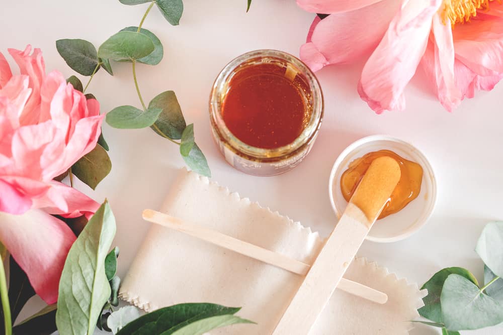 jar of wax and flowers