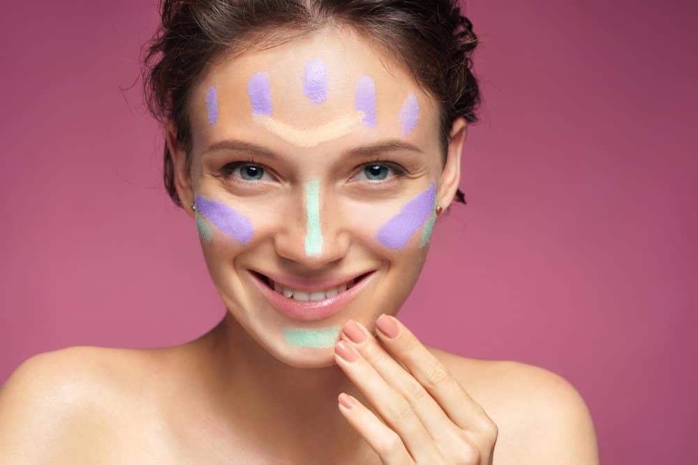 smiling woman with makeup splotches across face