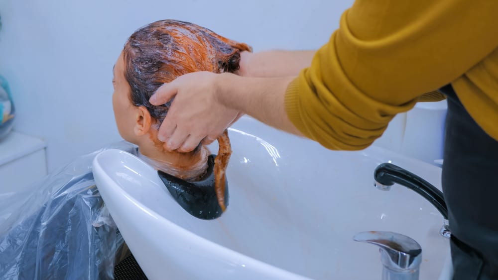 stylist treating orange hair