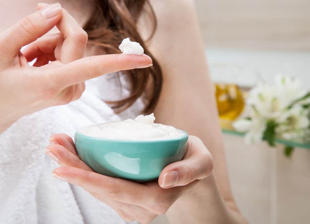 woman applying hair moisturizer