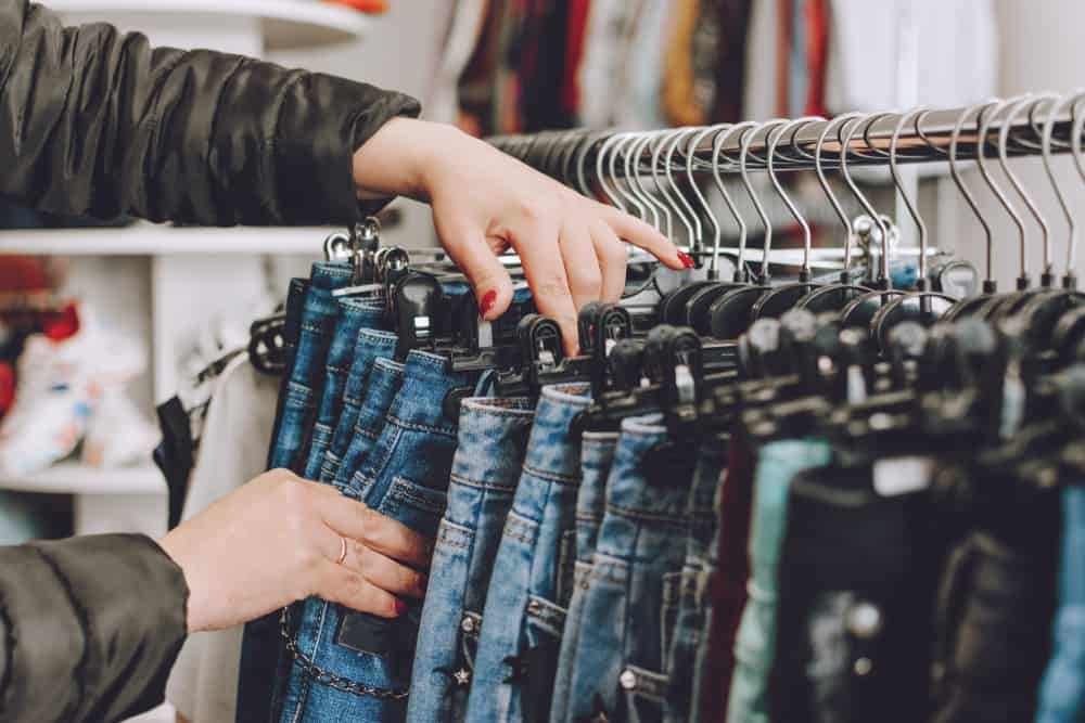 woman browsing jeans on rack