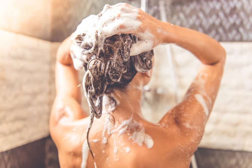 woman washing hair with shampoo