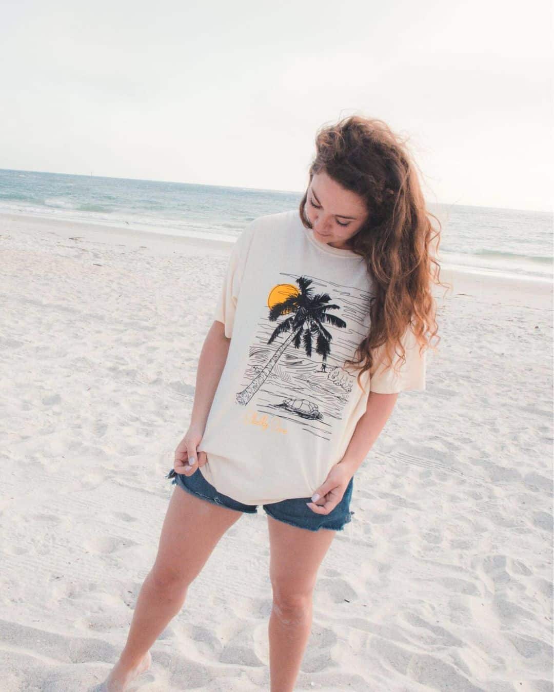 Woman on the beach wearing tropical turtle shirt