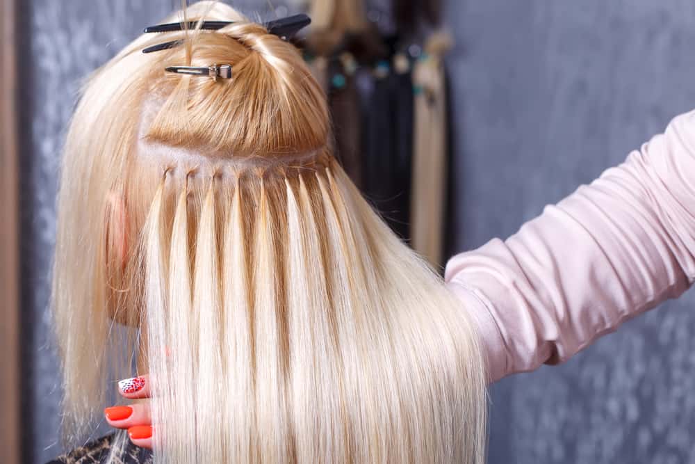 hair extensions being applied