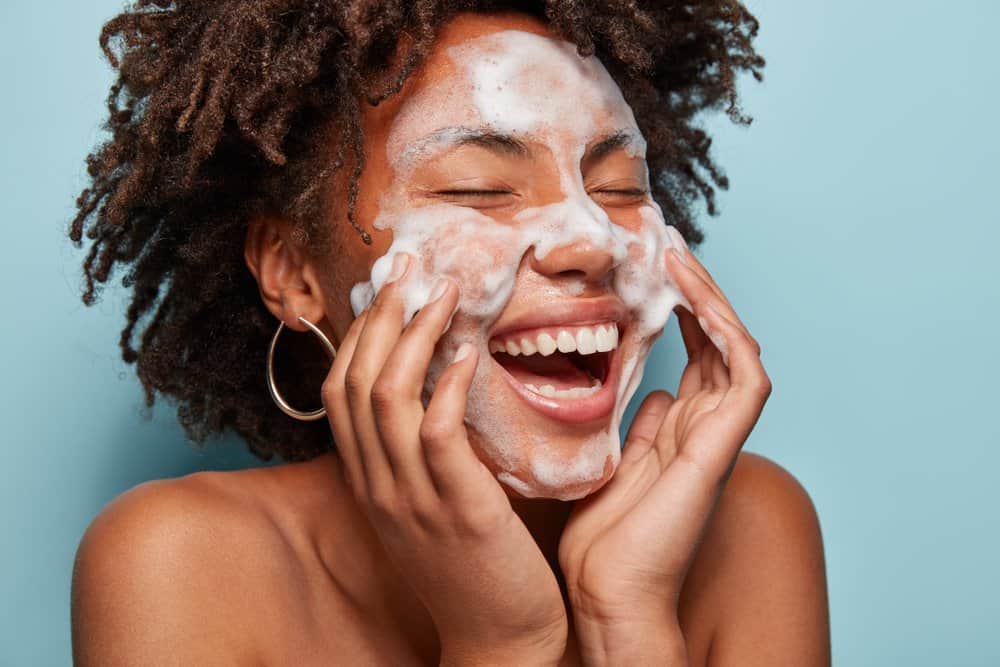 woman applying foaming cleanser