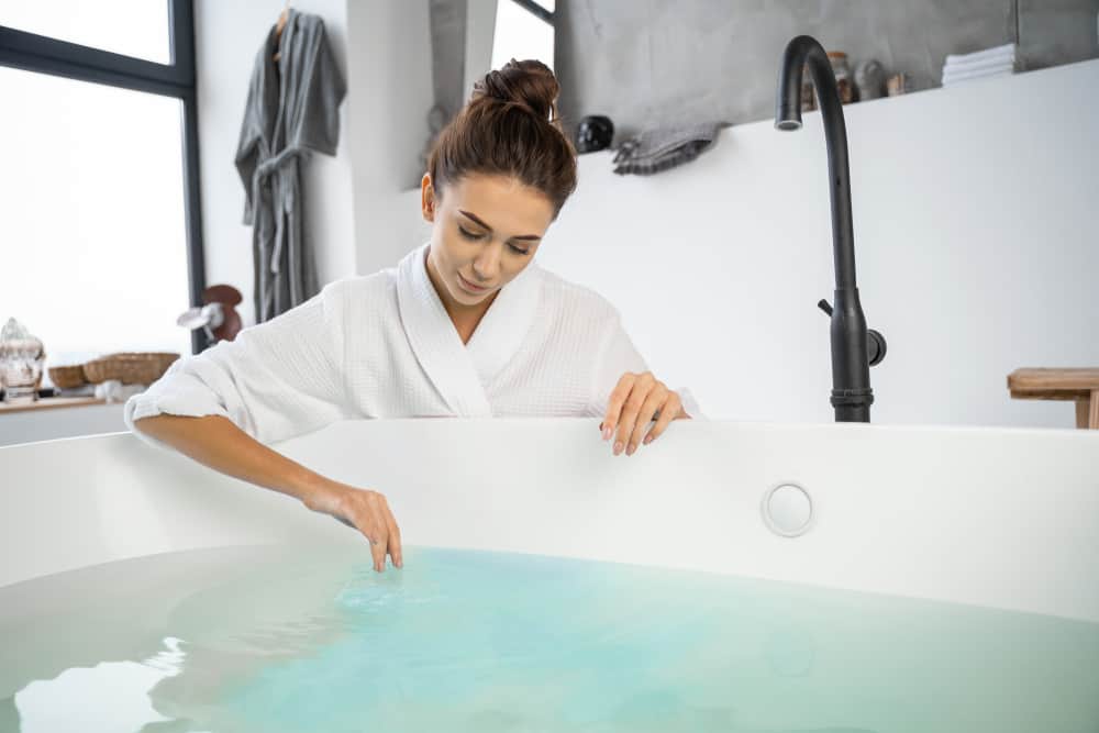 woman drawing bath water