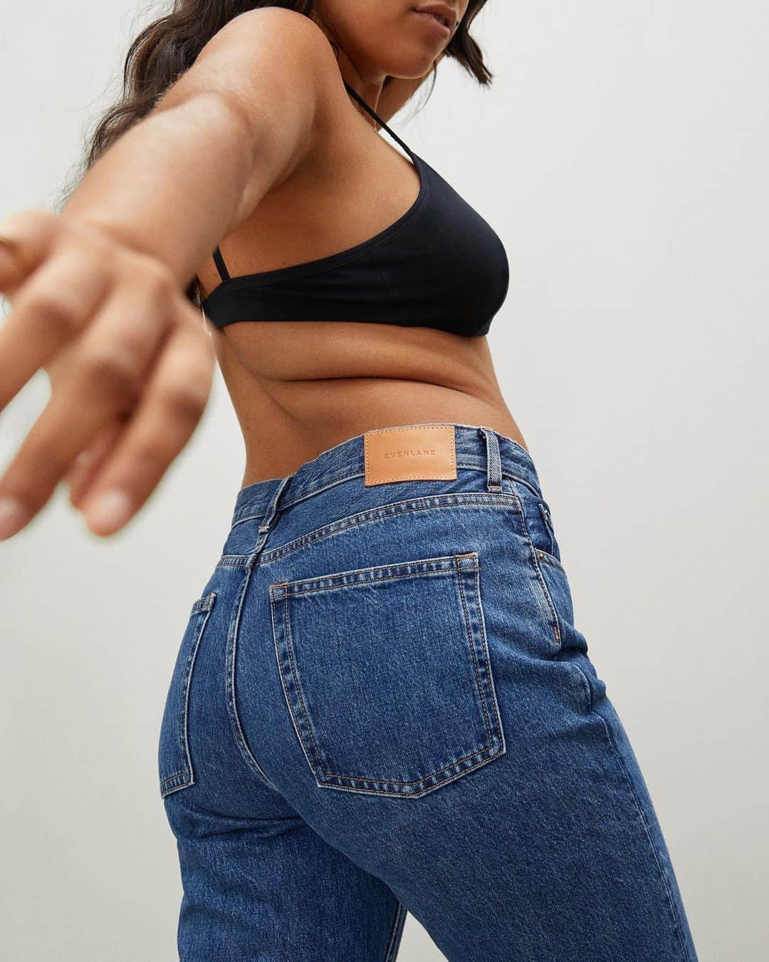 woman in bra and everlane jeans
