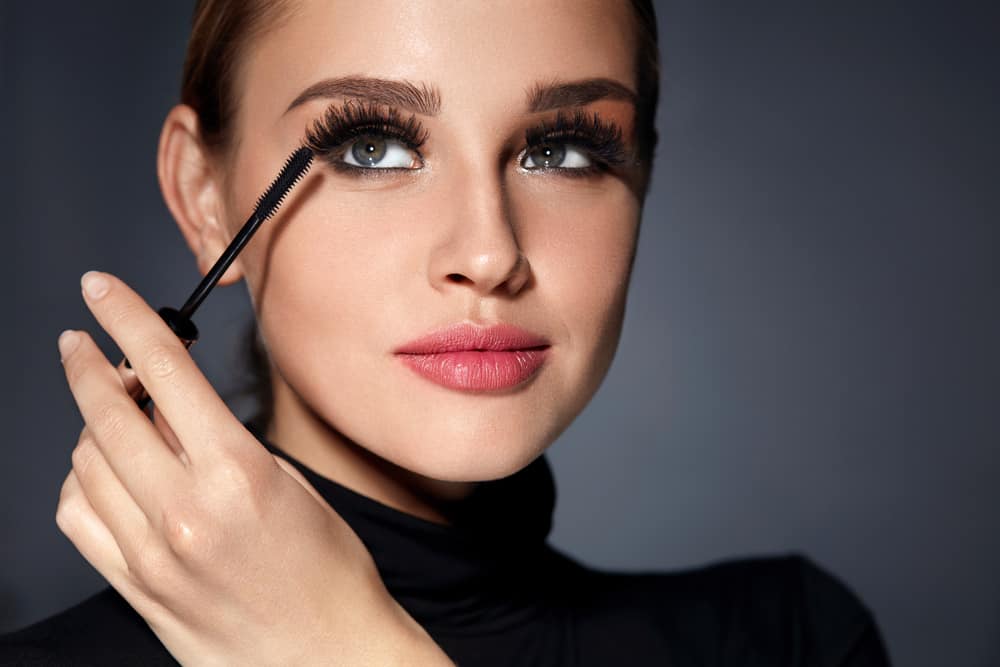 closeup of woman applying mascara