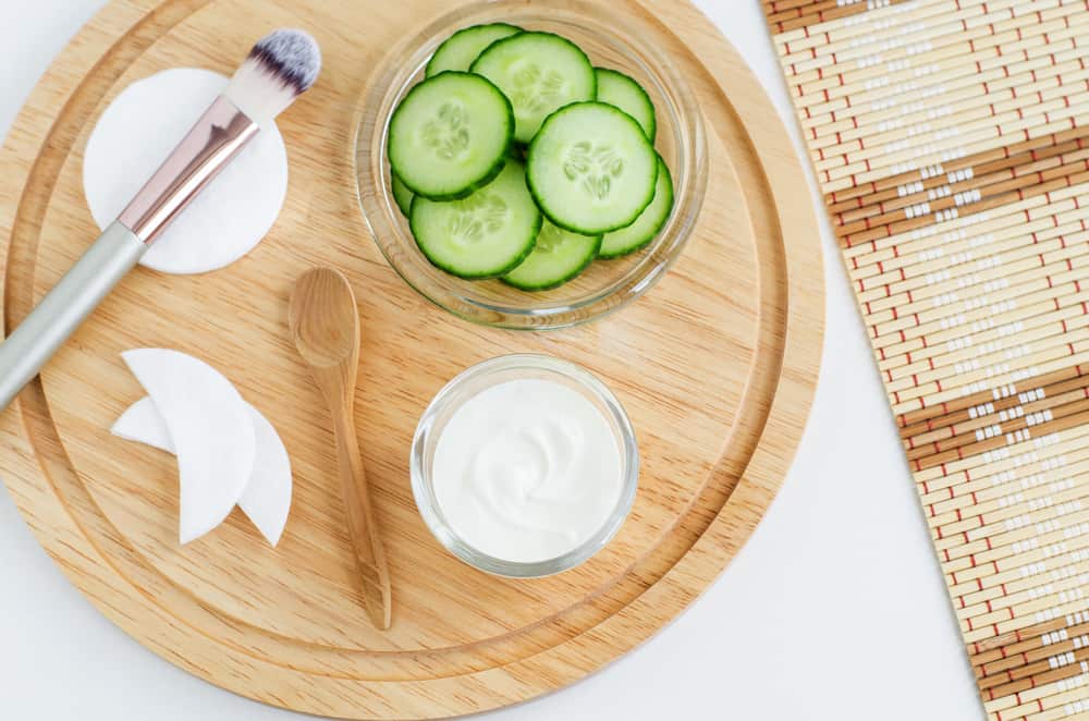 eye cream jar next to cucumbers