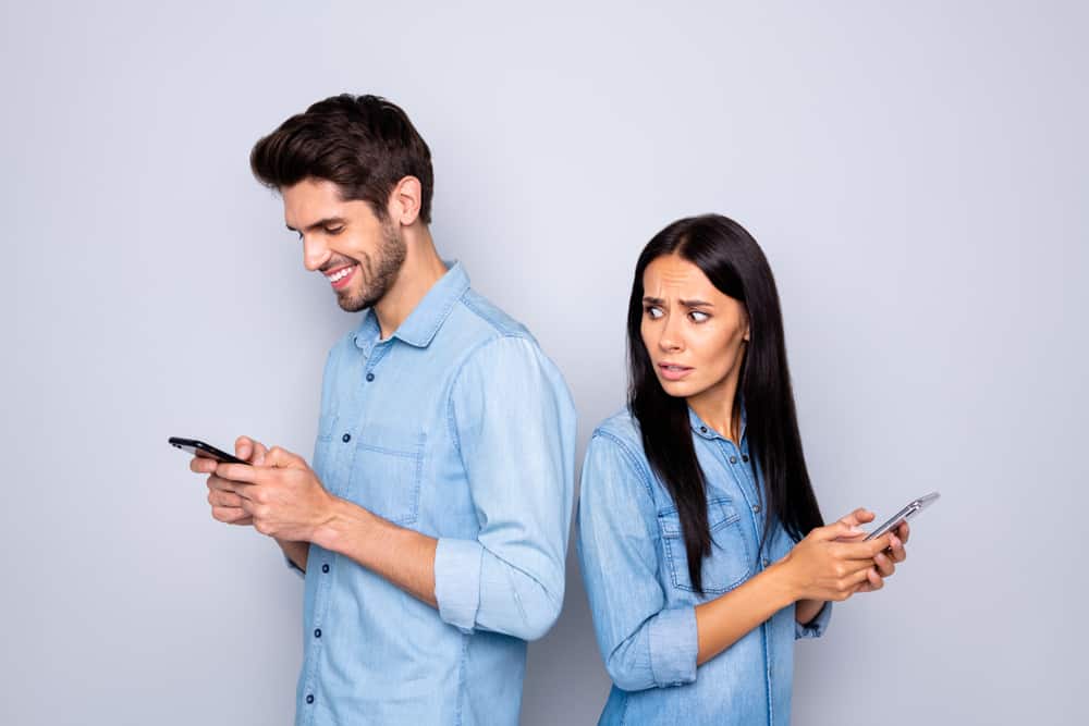 man and woman texting separately