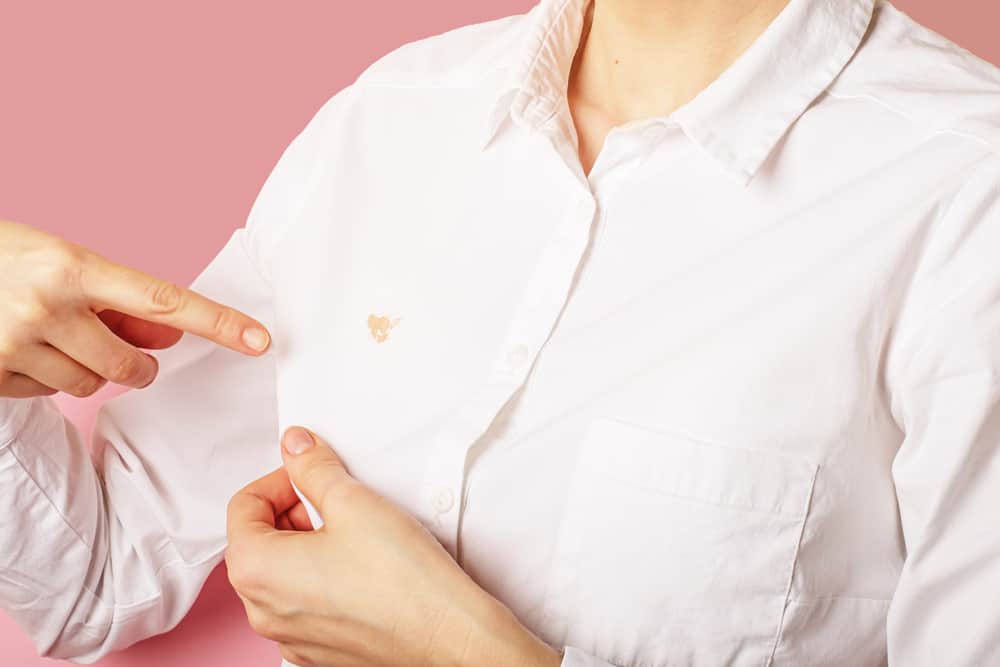 person with foundation on white shirt