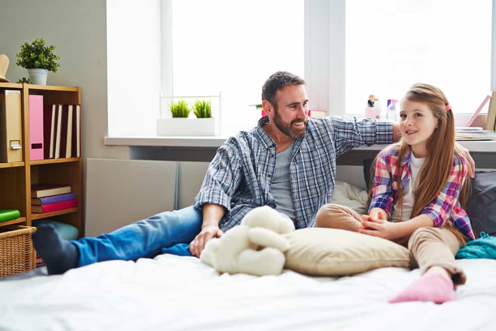 teenage daughter talking to father