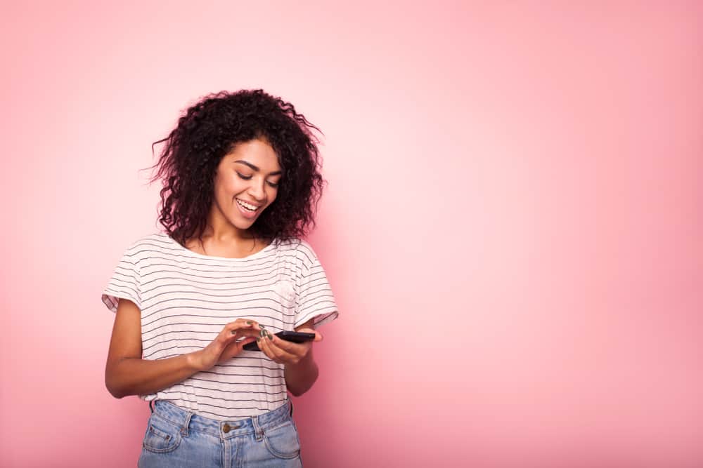 woman texting and smiling