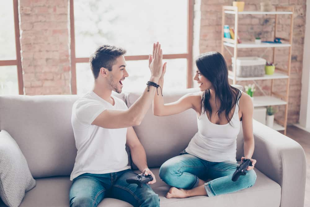 couple high-fiving while playing video games